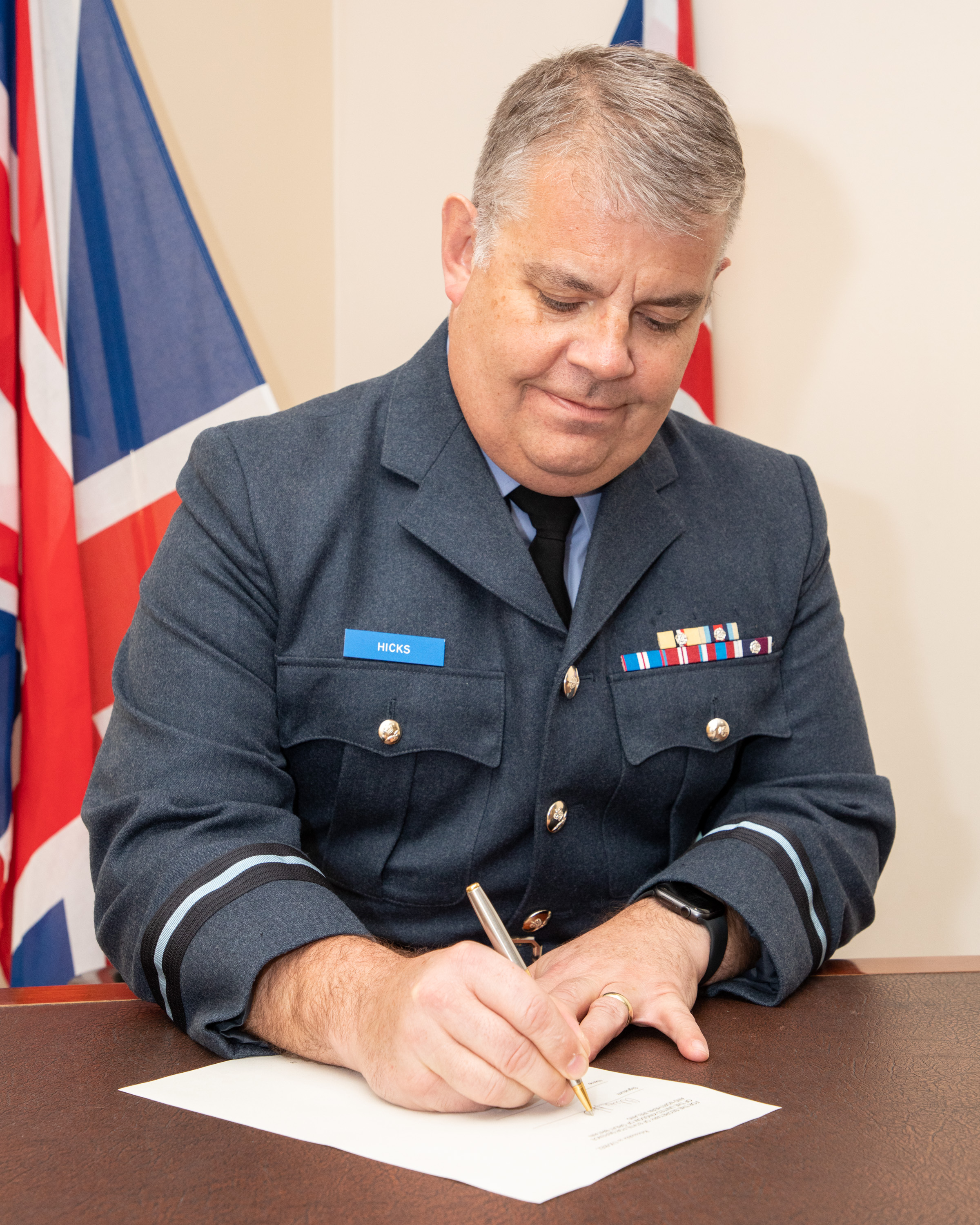 Image shows RAF personnel signing agreement.